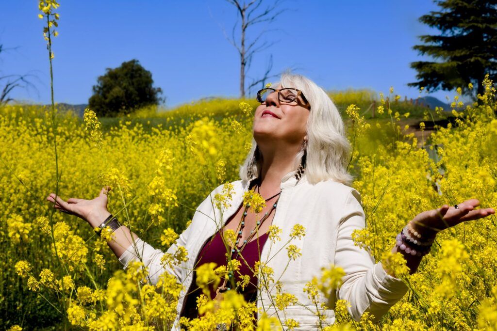 clarissa-feminine-fire-healing-flower-field-yellow-open-arms