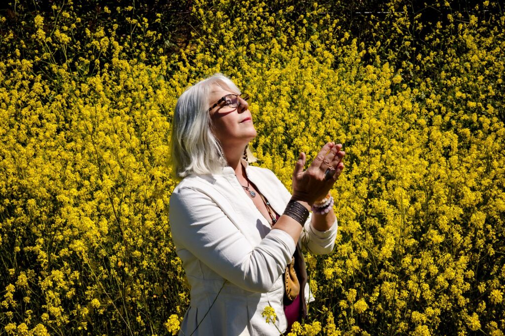 clarissa-feminine-fire-healing-flower-field-yellow-praying-hands